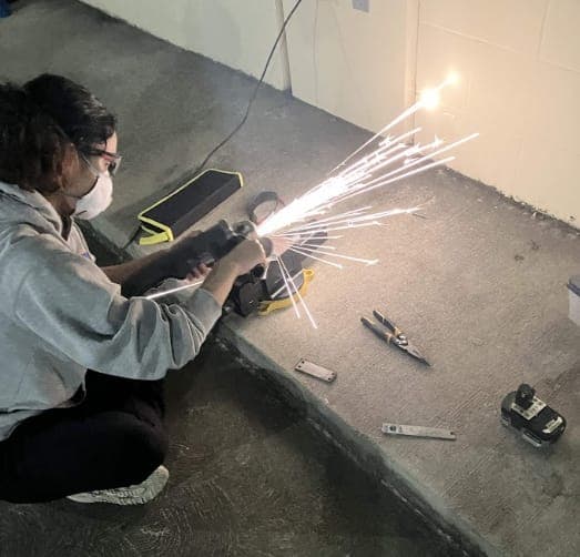 Grinding the edges of a cut titanium part
