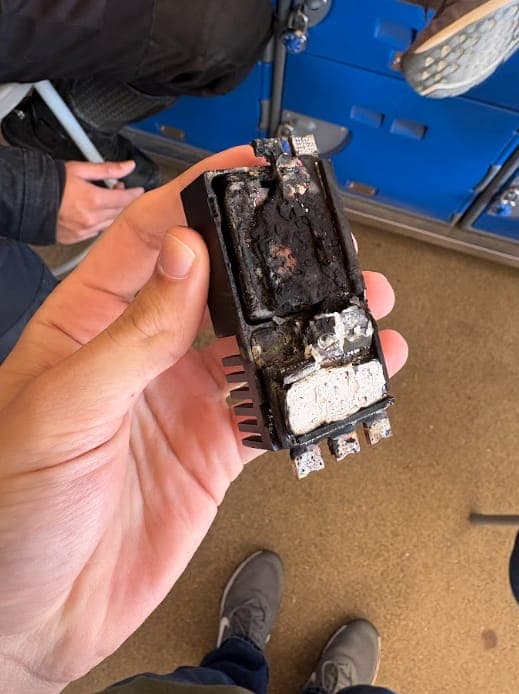 The burnt weapon ESC held in a hand
